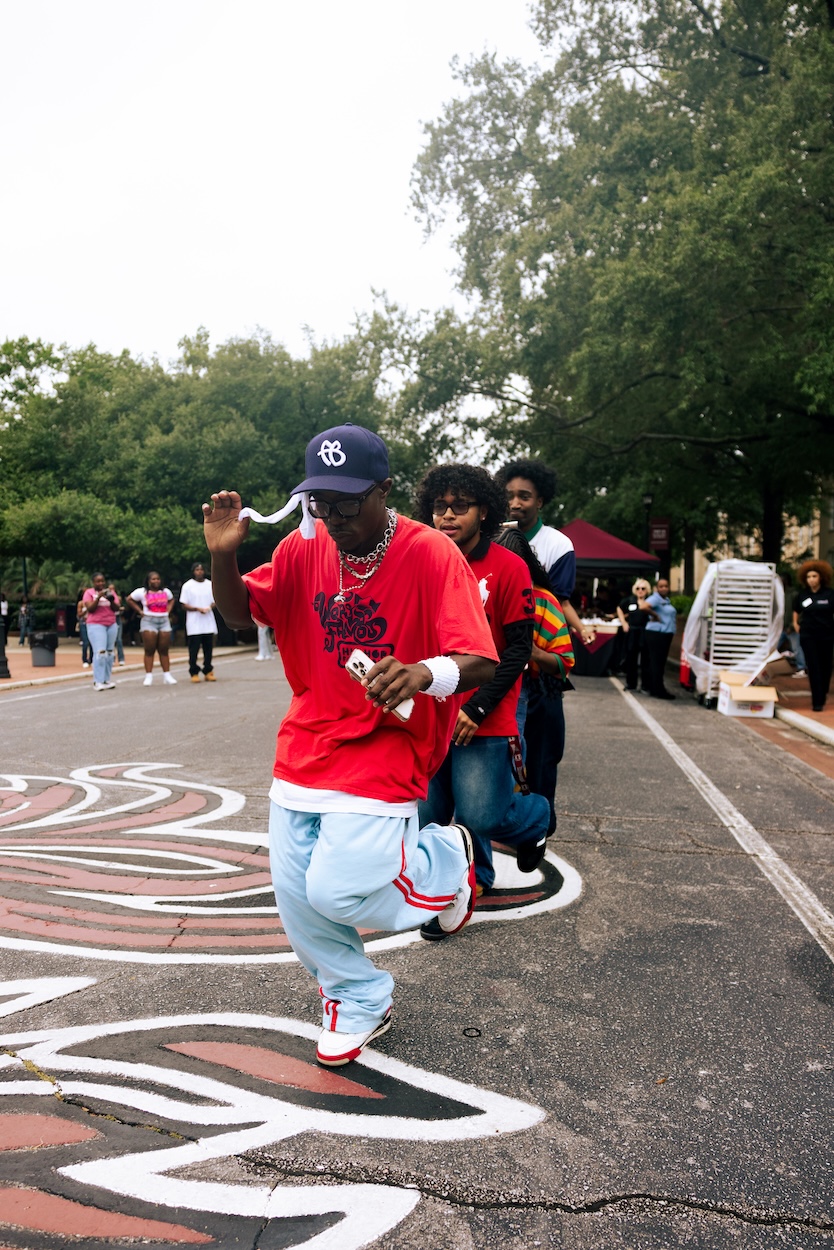 A male line dancing on greene street
