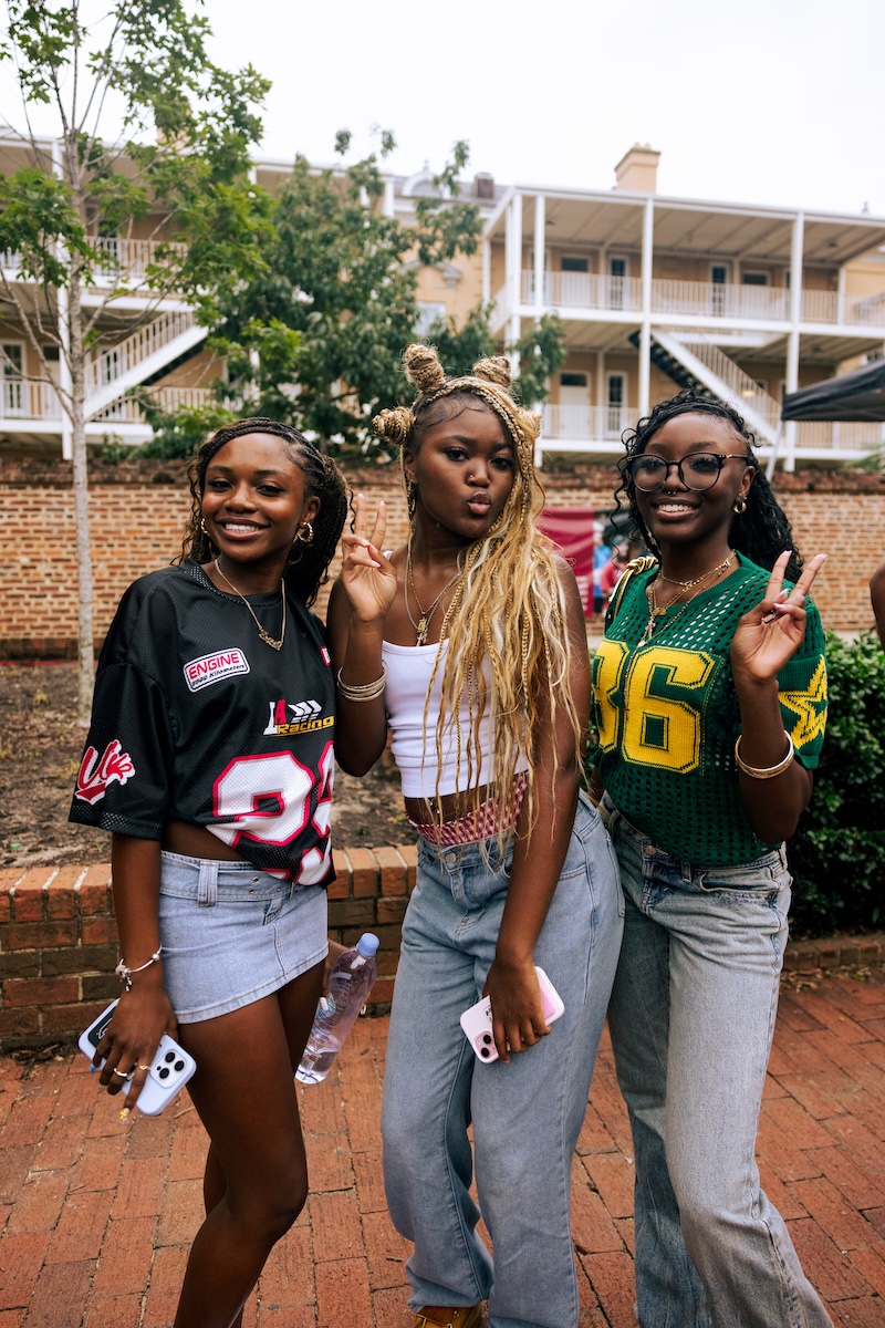 3 girls holding the peace sign