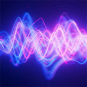 Neon pink and purple waves on black background depict how particles at the quantum level behave.