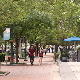 students walking on a sidewalk in downtown Columbia
