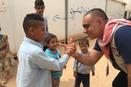 Moeen Saleem working with kids