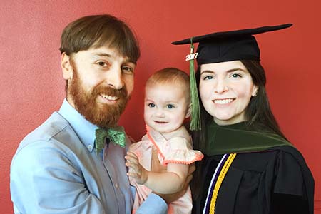 Sarah, Neil and baby Olive celebrate at the College of Pharmacy's convocation.