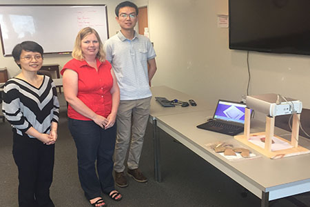 Jun Zhou, Karen Smith and Yuhang Lu work with 3D scanner and pottery