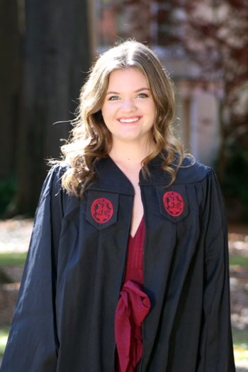Senior nursing major, Shannon McDade standing on the horseshoe in her graduation gown.