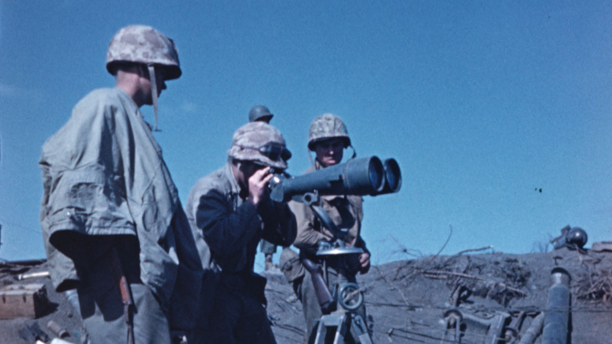 Soldiers looking through binoculars at the Battle of Iwo Jima.