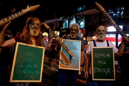 Protesters wear masks of the Brazilian educator Paulo Freire during a demonstration in support of public education in Brazil