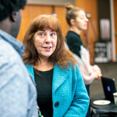 Oral historian Andrea L'Hommedieu talks with a student at a library event