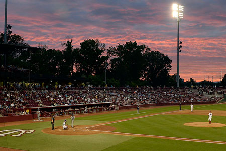 Photo of a baseball game at Founders Park. It was taken at sunset and shows the pink and purple sky.