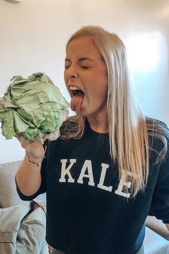 Junior philosophy major and president of the UofSC lettuce clube, Kailey Houck, pretending to bite into an entire head of lettuce.