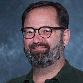man with beard and blue shirt Christian K. Anderson, associate professor of educational leadership and policies at the University of South Carolina