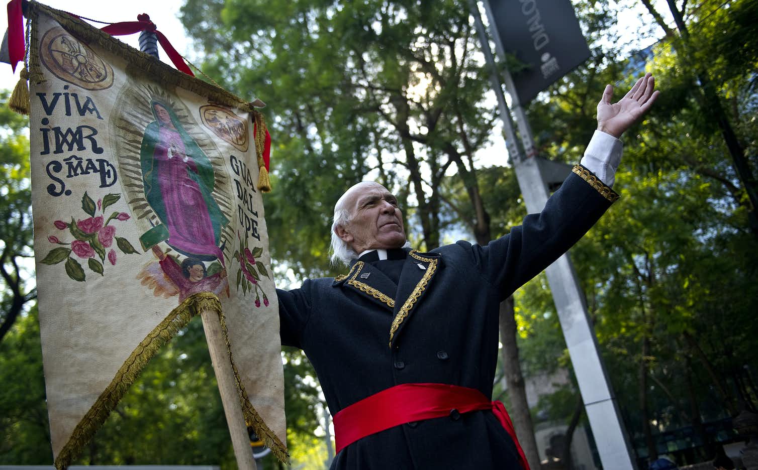 Mexican priest and independence fighter Miguel Hidalgo and a banner of the apparition of the Virgin of of Guadalupe. 