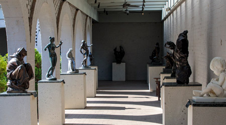 Row of statues on podiums.