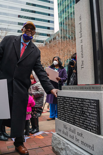 the rev. james edwards touches a monument to protestors in the 1961 march that will be permanently installed at a later date