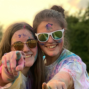 Cecelia Tatro and her friend covered in chalk dust from a color run.