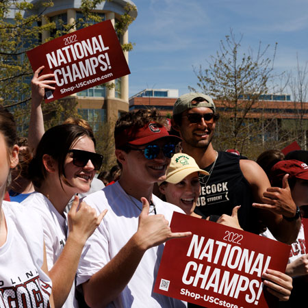 fans holding signs at parade