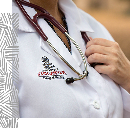 A person wearing a University of South Carolina College of Nursing lab coat with a stethoscope around their neck.