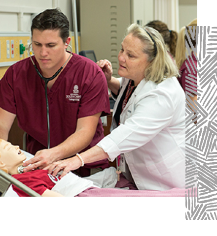 Nursing professor and a student leaning over a mannequin listening with a stethoscope.