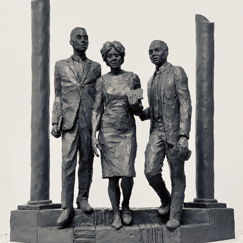 small scale sculpture depicting three people on the stairs of a building