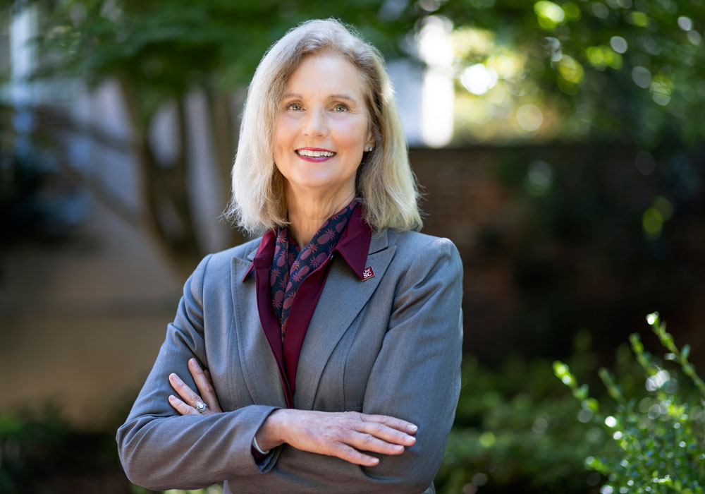 Donna Arnett crosses her arms and smiles on the Horseshoe