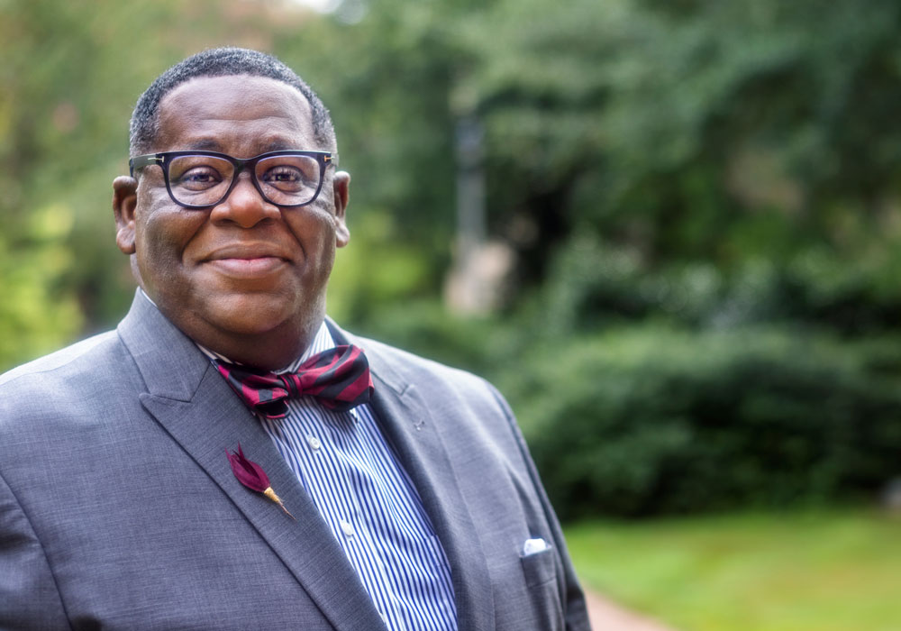 A shot of Rex Tolliver standing outside wearing a bowtie