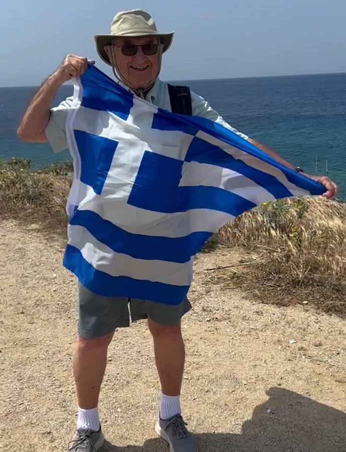Stan Papajohn holds the Greece flag.