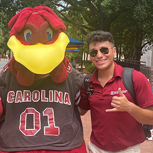 Alex Gallegos-Tinajero and a friend pose with Cocky on Greene Street.