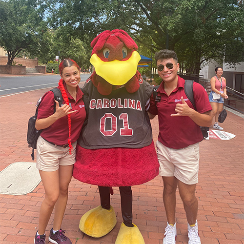 Alex Gallegos-Tinajero and a friend pose with Cocky during orientation.