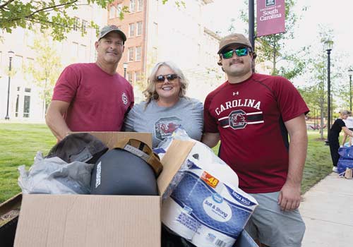 Cale Horton with his parents on move-in day.