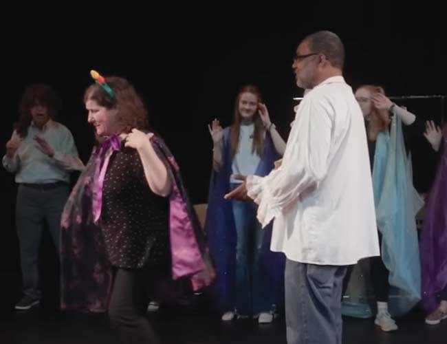 Aphasia drama club participants work through language difficulties on stage.