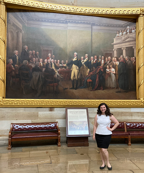 Gracie Vess standing in front of a painting in a museum. 