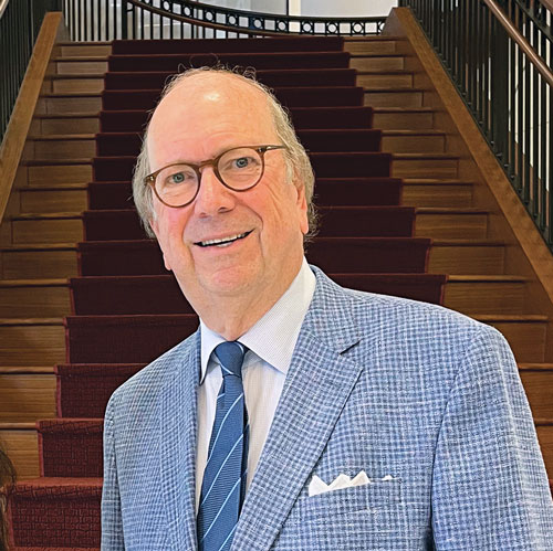 a man stands in front of a staircase