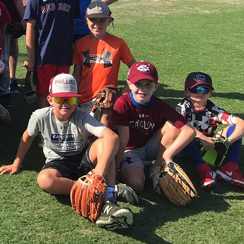 Children participate in the USC baseball camp