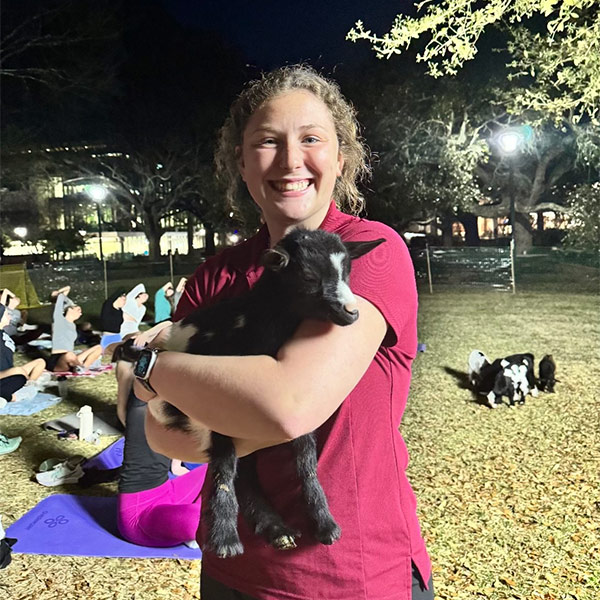 Caroline Sunderlage holding a goat on USC campus