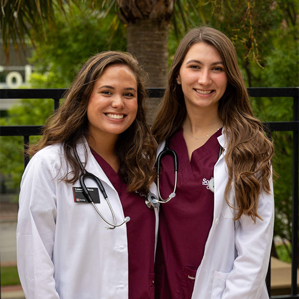 Lauren LaRosa, left, and a friend getting their nursing stehoscopes.