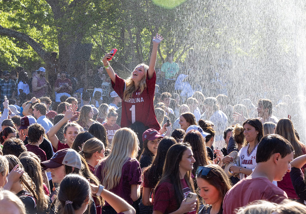 students celebrating in the library fountain
