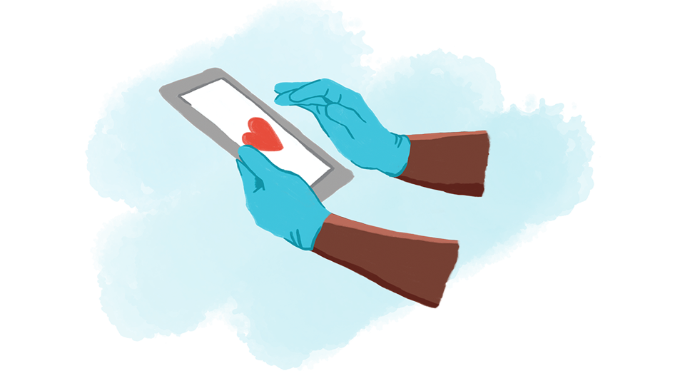 Gloved nurse's hands using a tablet with a heart on the screen.