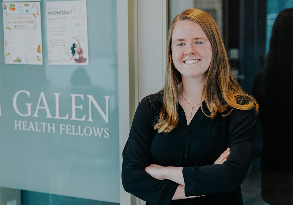 Student standing in front of Galen Health Fellows sign