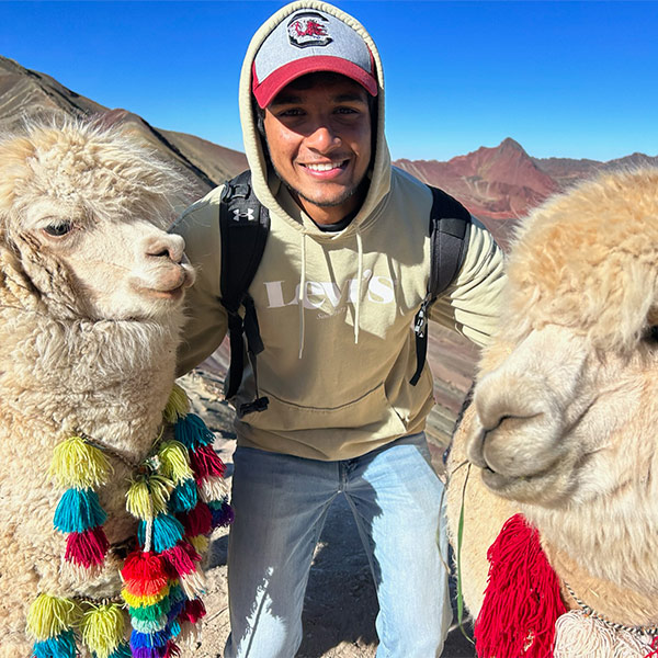 Shyam Ganesh Babu with sheep on a study away trip in Peru.