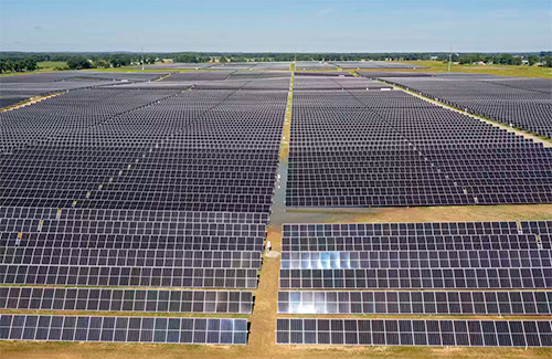 An aerial view of a sprawling solar farm on flat land