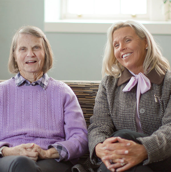 Two women sitting on a couch