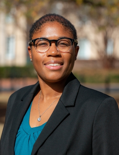 Aisha Haynes smiles in a business professional headshot on USC’s campus