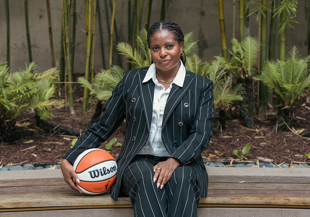 Jade Li-English sit outside with a basketball.
