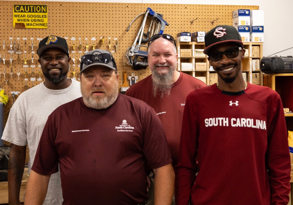 Locksmiths of USC Facilities pose for photo in the key shop.